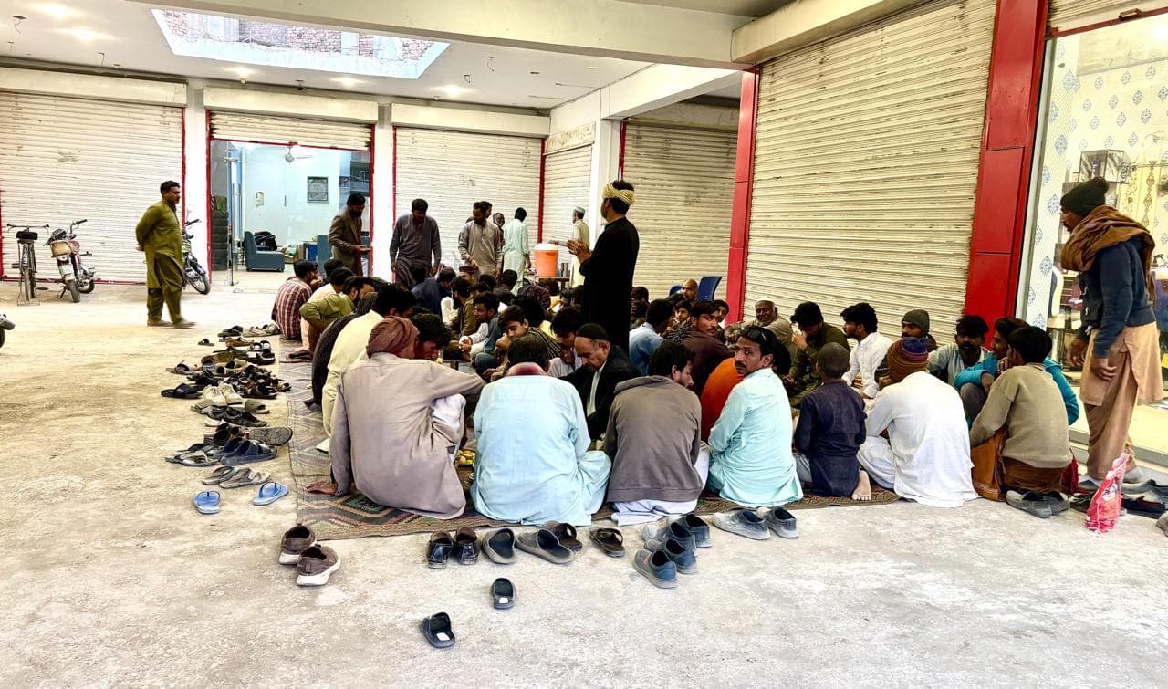 People seated together for an iftaar meal in Burewala