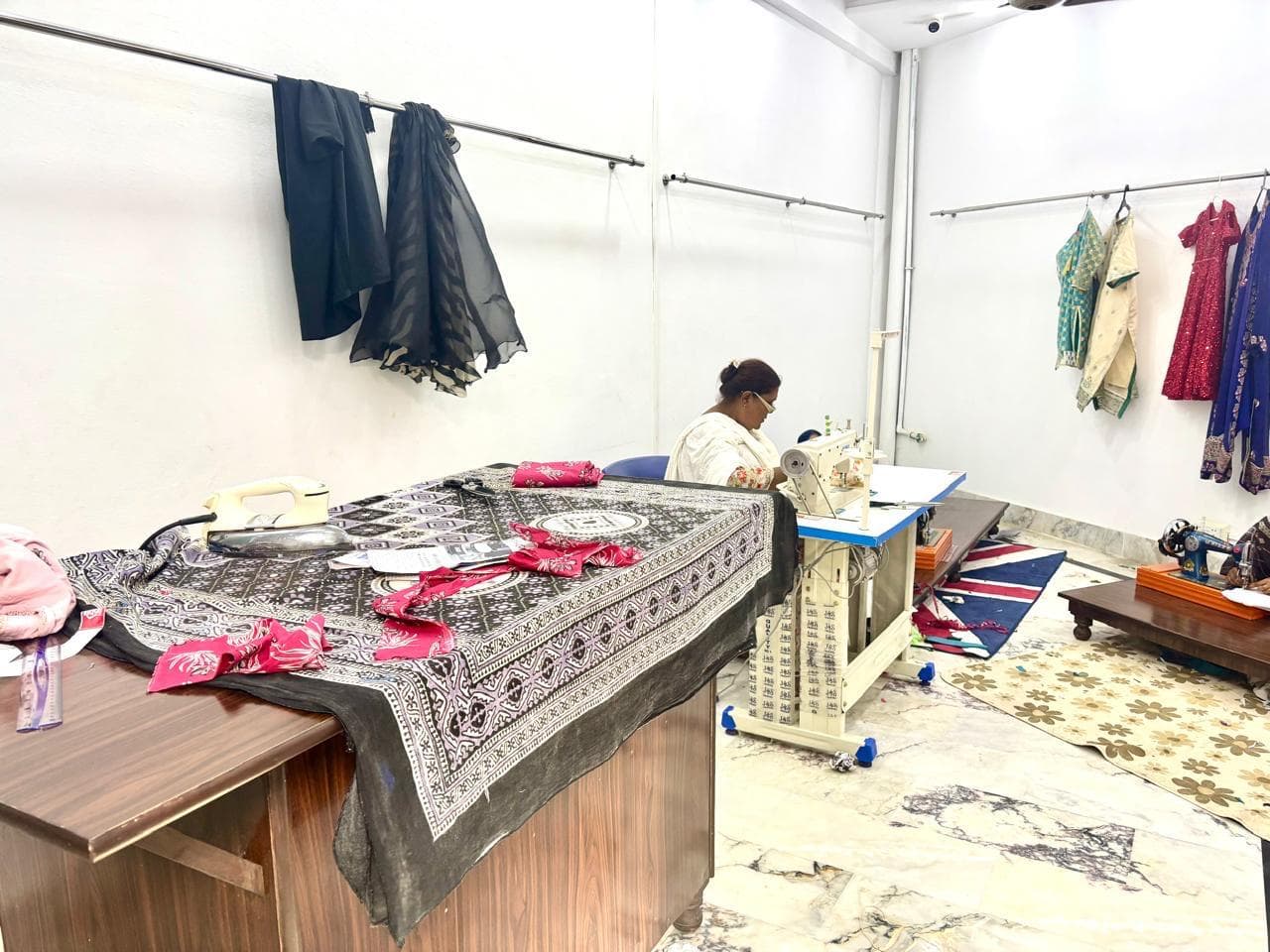Teacher working at a sewing machine inside the Stitch and Sew Centre